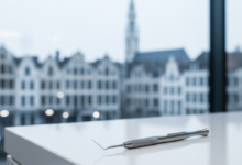 A close-up, photorealistic shot of a gleaming, modern dental instrument on a clean white surface, with a very soft-focus, blurred cityscape in the background.