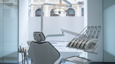 A pristine, high-tech dental clinic with a modern treatment chair and advanced instruments, bathed in cool, bright light. In the soft-focus background, blurred traditional European architecture hints at Belgium.