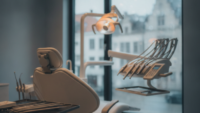 A clean, modern dental examination room with a state-of-the-art dental chair, sleek instruments on a sterile tray, and a blurred background subtly showing European architecture, conveying comfort and advanced dental care.