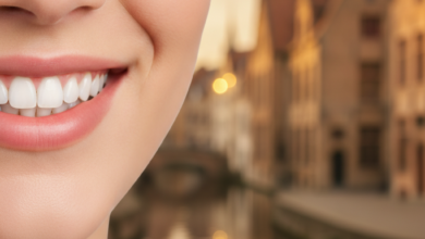 Close-up of a healthy, bright smile with pristine teeth, set against a softly blurred background featuring the characteristic canal-side historic buildings and quaint streets of Bruges, Belgium.